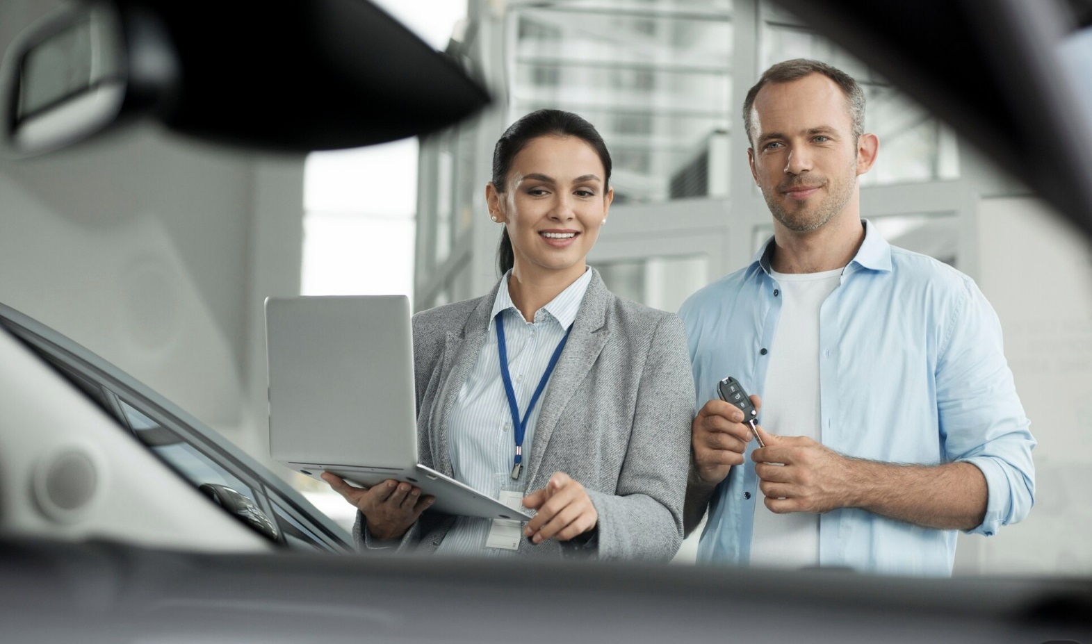Insurance specialist reviewing policy options with a driver